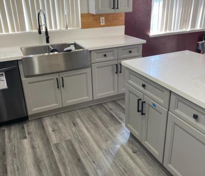 New clean kitchen. White cabinets and grey floors. 