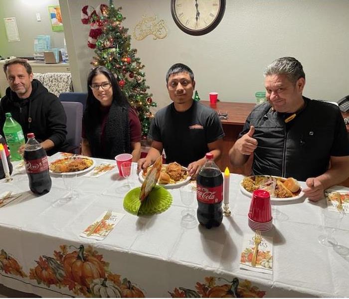 Our SERVPRO team enjoying their Thanksgiving dinner around our fully decorated table. 